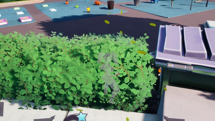 A Rumbleverse player hides inside a bush, but floating leaves give away her position.