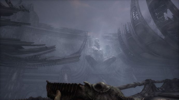 A wide shot of an area in scorn, showing a huge statue of a woman crouching, her legs spread open.