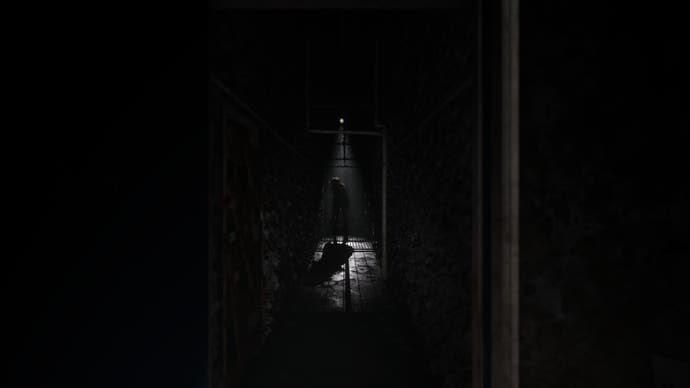 Silent Hill: The Short Message promo screenshot showing a very nearly pitch black corridor with a mishapen figure at the end.