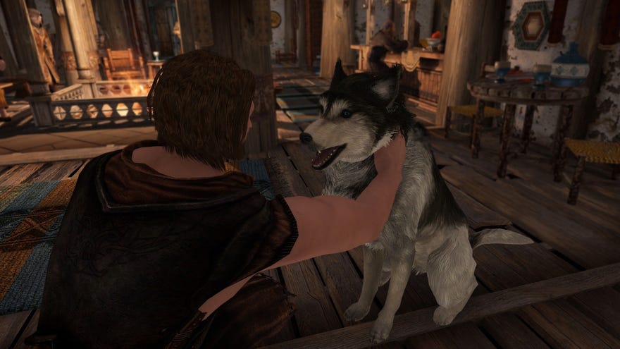 Skyrim - A player character is kneeling and petting a husky.
