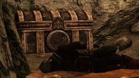 A bandit sleeping in front of a locked chest in a Skyrim screenshot.