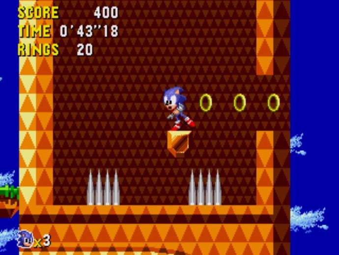 A screen from Sonic CD, sonic standing on a small ledge between two spike traps
