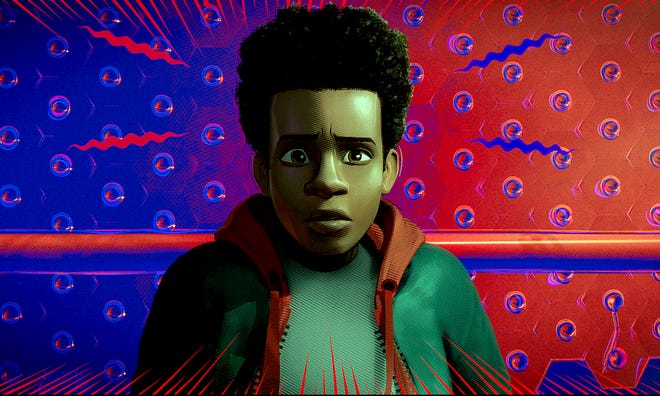 Still animated image of a young man wearing a white shirt and a black jacket and red hoodie. Behind him, the background is split in red and blue, long squiggly lines are emanating from the direction of his head.
