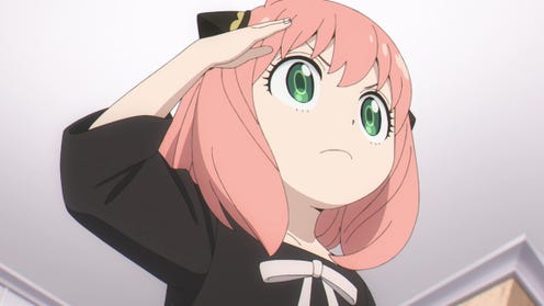 Image taken from the Spy x Family anime, showing one of the main characters Anya Forger doing a cute salute.