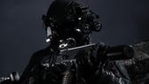 A character aims a gun during nighttime in MW3