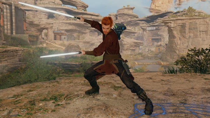 Cal Kestis, hovedpersonen i Star Wars Jedi: Survivor, stående foran et stenet landskab og branding af to lyssabelblade