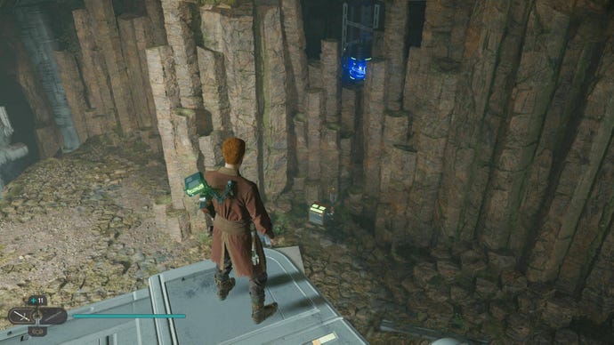 Cal walks up to the edge of a ledge and spots a chest on the ground below him in Jedi: Survivor.