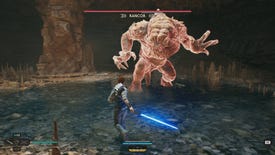 A rancor about to do an unblockable attack, in a fight with jedi Cal Kestis in a cave in Star Wars: Jedi Survivor