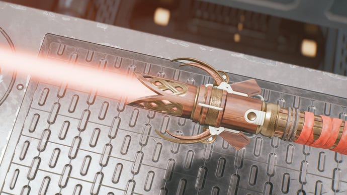 A close-up view of an ornate lightsaber with a red blade in Jedi: Survivor.