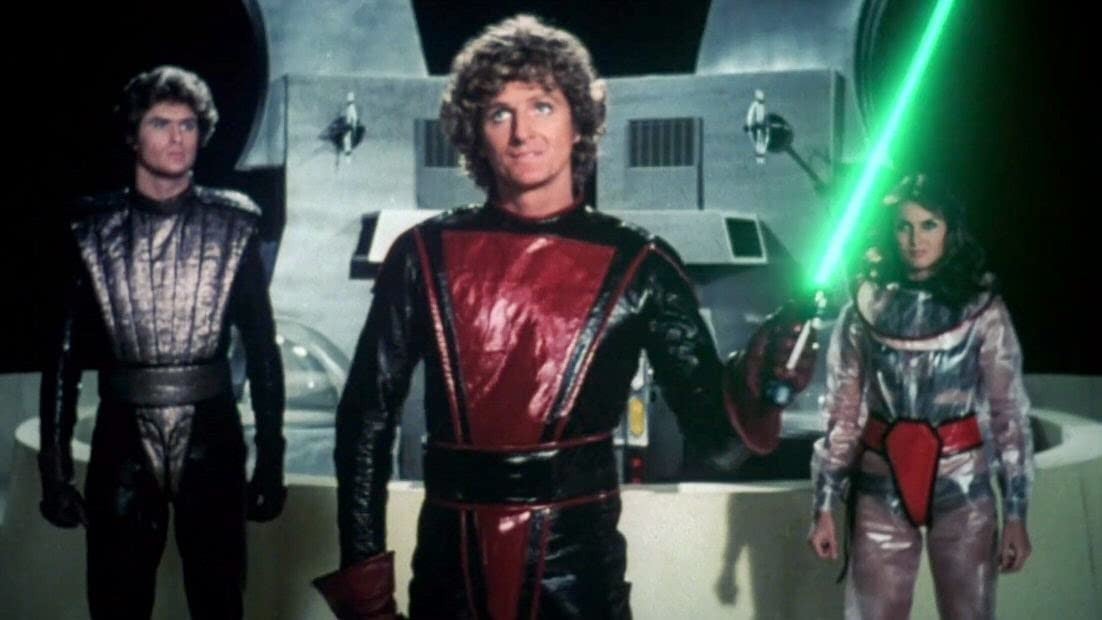 Laser swords and jumpsuits in a Starcrash screenshot.
