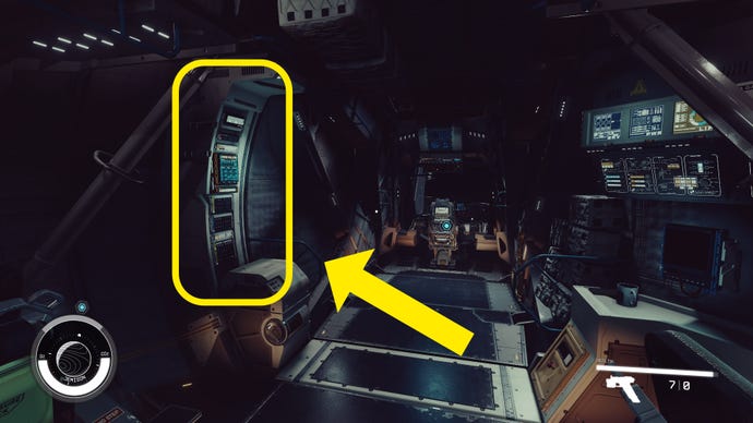 The player walks toward the cockpit of their ship in Starfield. A yellow arrow points to the location of the Cargo Hold console.