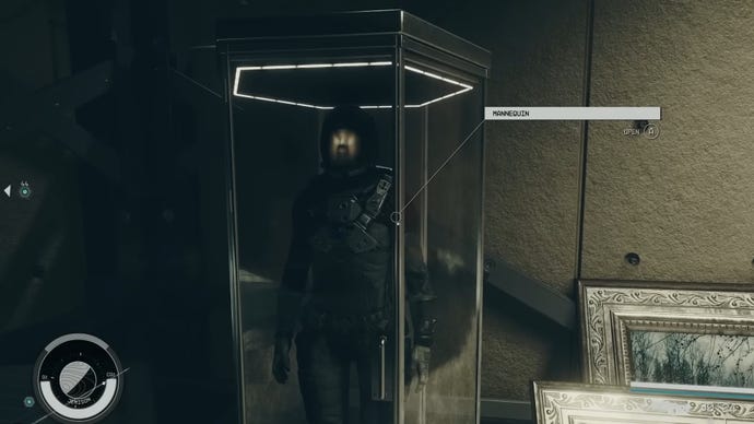 A player in Starfield looks at a mannequin wearing a spacesuit behind a glass cabinet.
