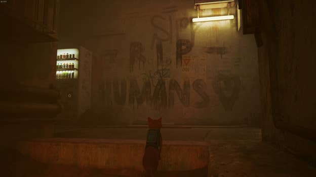 The cat looks at graffiti reading 'R.I.P. HUMANS' in Stray.