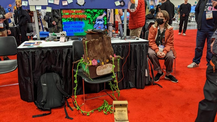 A papier-mache tree stump and a foot pedal are perched on a chair at GDC