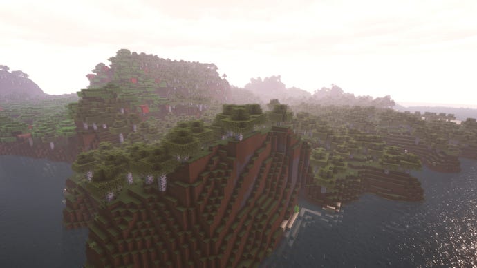 A Minecraft hills landscape surrounded by a river.