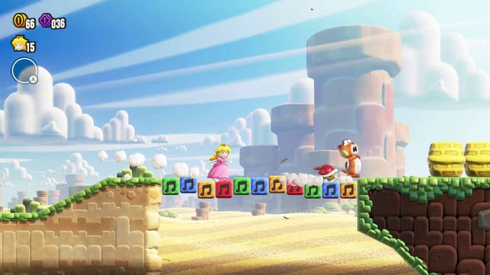 Mario and Peach cross a bridge made of primary-coloured blocks in Super Mario Wonder.