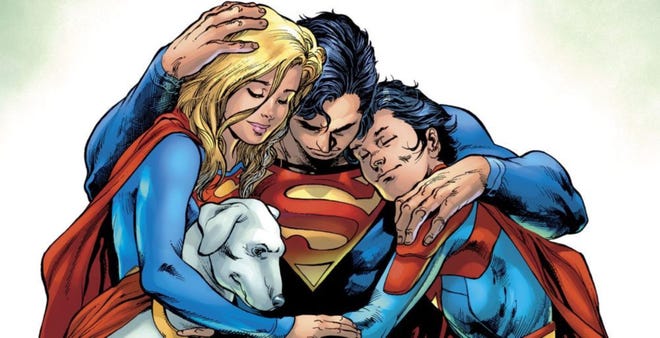 Superman hugs Jon, Supergirl, and Krypto