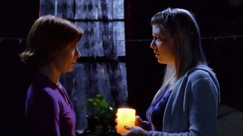 Tara and Willow holding a candle