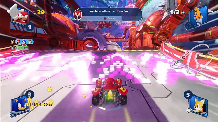 A screenshot of Team Sonic Racing gameplay that shows Knuckles being offered an item box transfer right before he hits a speed boost ramp