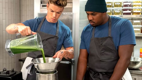 Production still of The Bear featuring Marcus watching a chef pouring from a blender into a strainer