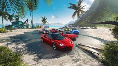 The Crew Motorfest promotional screenshot showing a red sports car and several other brightly-coloured cars behind it on a tropical beach in Hawaii, with blue ocean, palm trees, and green mountain surrounding them.