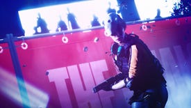A player character from The Finals holds a sub-machinegun while wearing a smiley face mask on top of her head as an audience of silhouettes looks on.