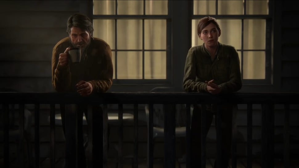 A screenshot from late into The Last of Us, Part 2 shows Joel and Ellie in a flashback leaning against the porch of a house late at night. They talk, but it is strained - the emotional distance between them is so heavy it permeates the space of the scene.