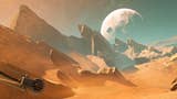 A sweeping vista of an alien planet. It looks quite a lot like a desert scene from Earth, to be honest. The orange sand gives way to huge, jutting rocks. But in the background, there's a huge, low-hanging moon, and a turquoise sky climbing to starry black.