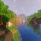 A screenshot of a river in Minecraft, with some trees on either side of the bank and a hill in the distance, taken using TME shaders.