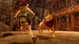 A screenshot from the remastered Tomb Raiders. We see Lara from behind as she hops away from a snarling lion, in a sandy, desert temple area.