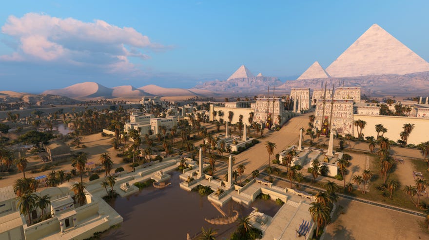 A shot of the ancient city Men-nefer in Total War: Pharaoh, under a blue sky with the great pyramids in the background