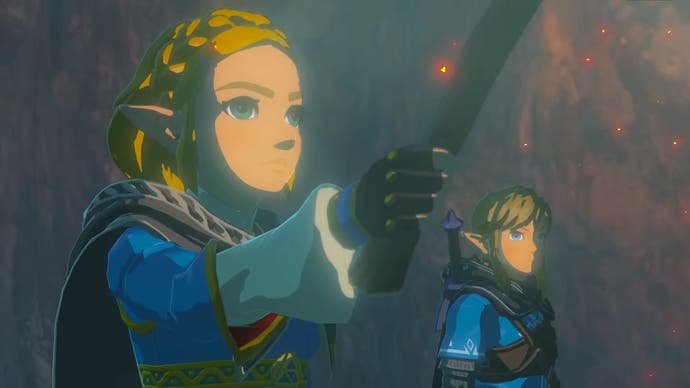 Zelda holds a torch as she and Link look at something in Tears of the Kingdom