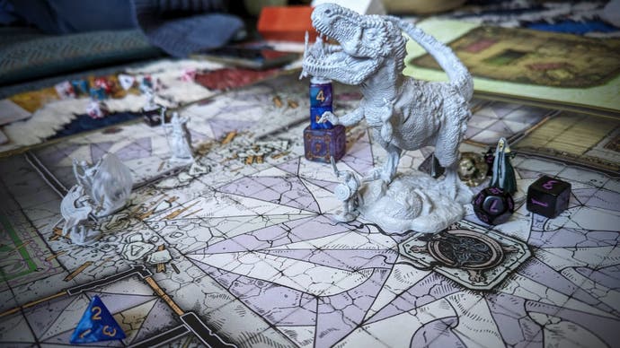 A photograph of a large, poster-sized Dungeons & Dragons floor map with various miniatures placed on top. There are a few fantasy humanoids around but the undeniable focus of the scene is a gigantic T rex. That's Bertie, that is, polymorphed for the occasion. It kept him in the fight.
