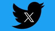 The Twitter bird logo with its new X inside, black on Twitter Blue background