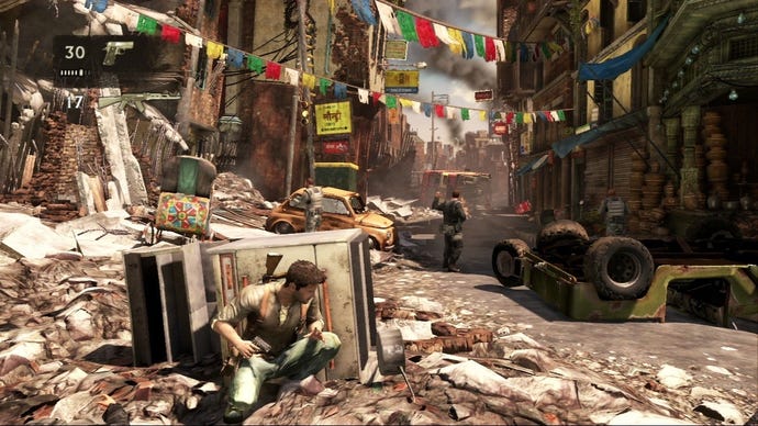 Drake takes cover behind an overturned hob as two soldiers go about their business in Uncharted 2.