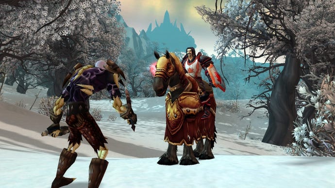An undead rogue and a human paladin square off on the snow.