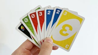 A hand of cards in UNO. From left to right: Wild card, green Skip card, red Skip card, red three, blue two, blue two and yellow three.
