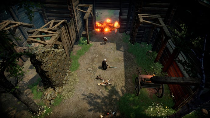 A human enemy in V Rising charges towards the player in the middle of a human village.