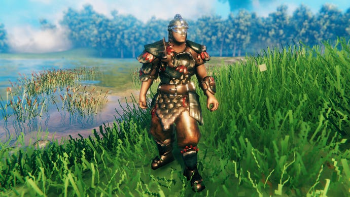 A player in Valheim stands on a Meadows coast and faces the camera wearing Carapace armour.