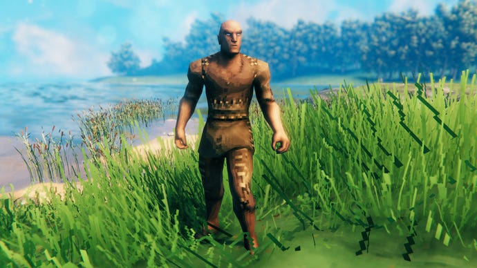 A player in Valheim stands on a Meadows coast and faces the camera wearing Rag armour.