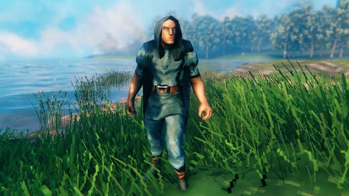 A player in Valheim stands on a Meadows coast and faces the camera wearing Troll armour.