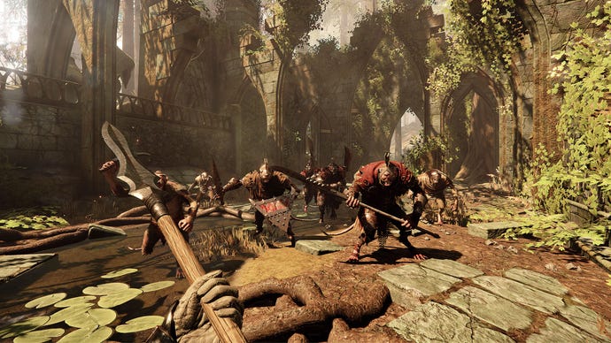 The player faces a horde of man-sized rat men in a ruined cathedral in Warhammer: Vermintide 2