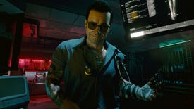 An image of the character Victor Vektor in Cyberpunk 2077, wearing glasses and standing near some computer displays.
