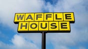 Waffle House sign against cloudy blue sky