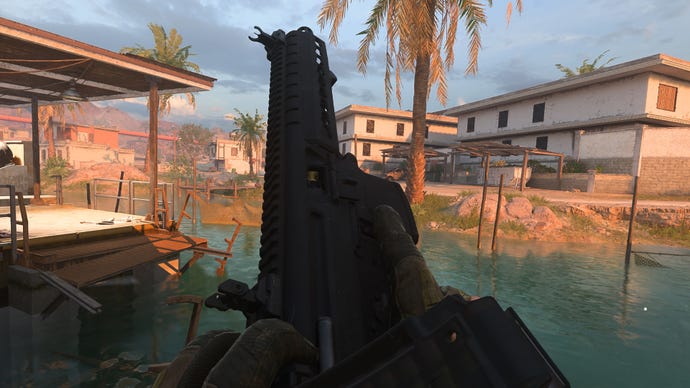 The player in Warzone 2 inspects their weapon, the BAS-P SMG.