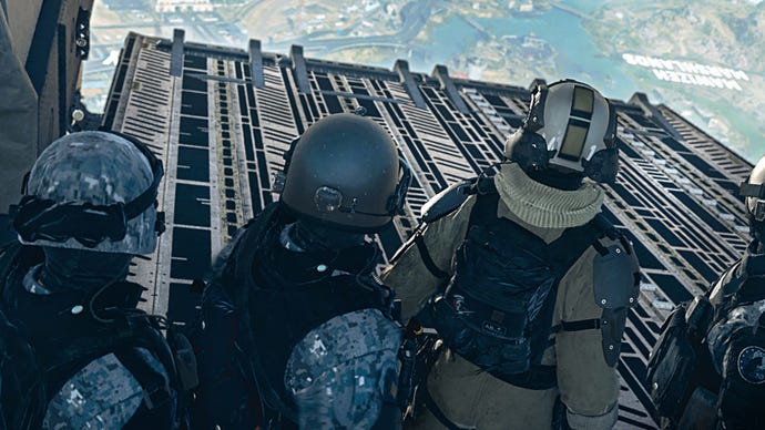A group of soldiers with their backs to the camera stand side-by-side in the bay of an aircraft and prepare to jump out of the plane in Warzone 2.0.