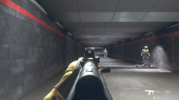 The player in Warzone 2.0 aims at a training dummy with the Kastov-74U ironsights.