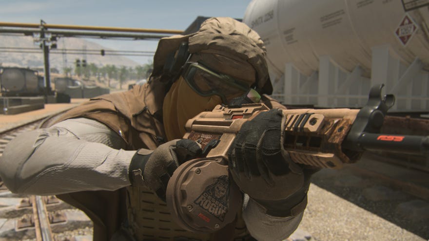 A soldier aims their LMG at a target somewhere off-screen in Warzone 2.0.