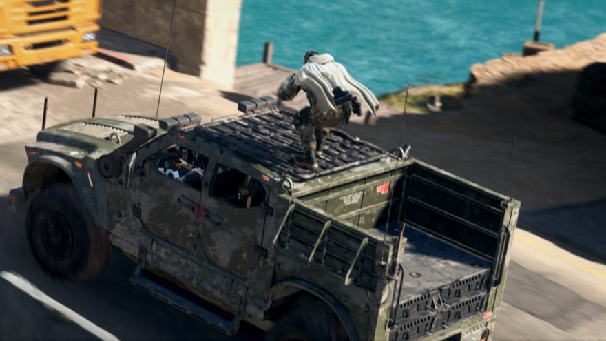 A soldier stands atop a moving vehicle in Warzone 2.0.