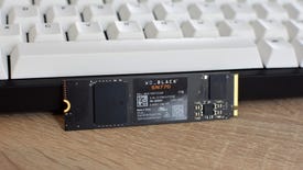 The WD Black SN770 SSD propped up against a gaming keyboard.